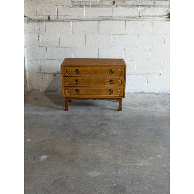 Beautiful vintage Danish three-drawer chest crafted in warm oak with classic Scandinavian modern details. This elegant...