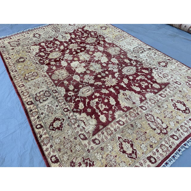 This elegant Sultanabad rug features an open, allover composition of palmettes, blossoms, and trailing vines in soft ivory...