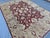This elegant Sultanabad rug features an open, allover composition of palmettes, blossoms, and trailing vines in soft ivory...