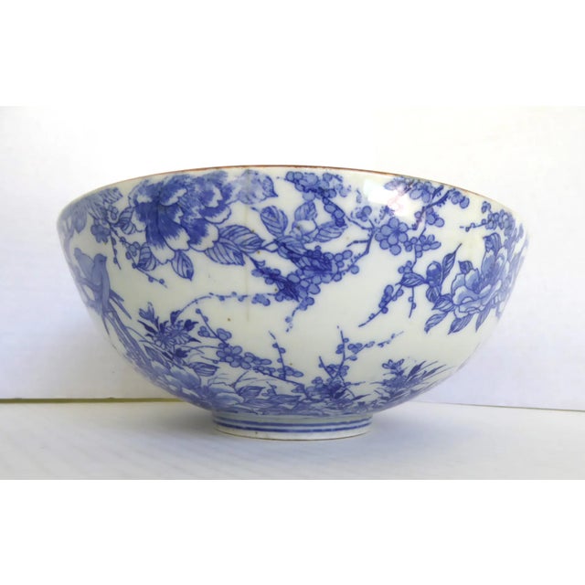 Lovely pair of Japanese porcelain bowls with transfer design in blue / white. The outer blue design of pair of birds on a...