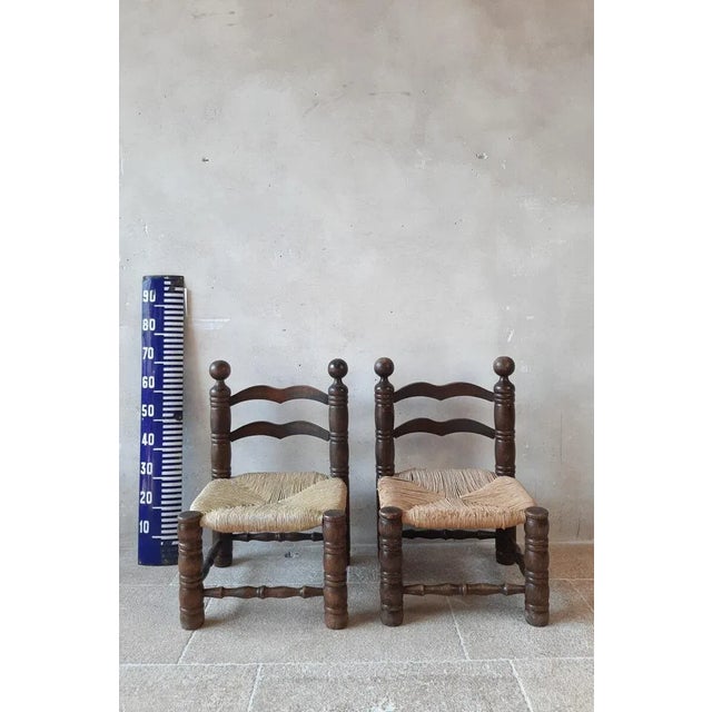 Pair of finca style chairs by charles dudouyt. Small fire side chairs with beautiful carved oak frames and rationalist...