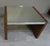 This coffee table, produced in the 1970s, features an elegant burl veneer and a mirrored top and edges, creating a refined...