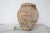 An hand made terracotta pot originally submerged under sea and used as a trap for an individual octopus. This pot has a...