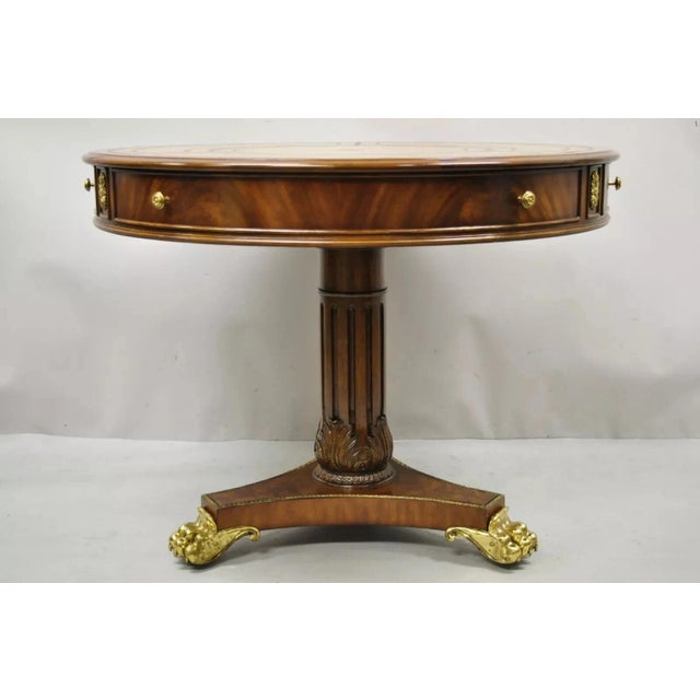 Maitland Smith French Empire Regency Leather Top Brass Paw Feet Drum Center Table. Item features brass rolling casters,...