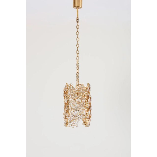 One of three palwa gilded brass and crystal glass encrusted pendant lamps, model s107. The lamps are handmade and in...
