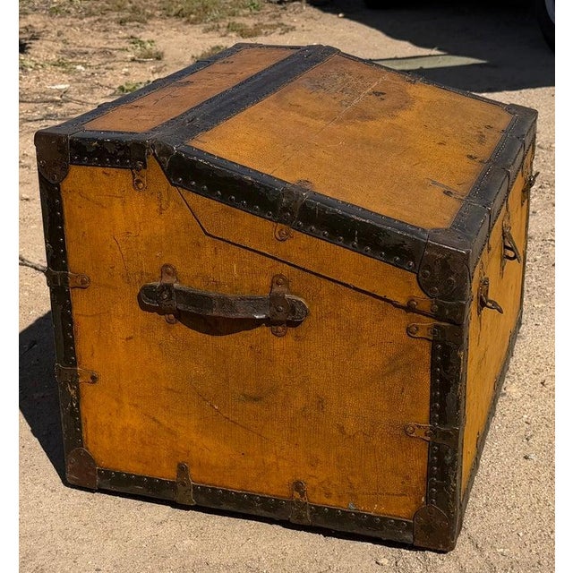 19th century wooden canted trunk with brass and iron fittings. Wonderful old paint. Slats have been added to the bottom of...
