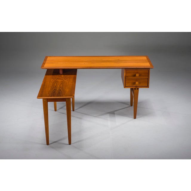 Rare mid-century l-shaped teak desk featuring a practical side return and two drawers. Most likely a bespoke piece,...
