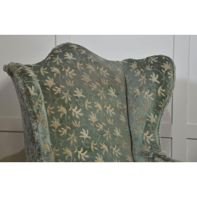 This handsome pair of generously proportioned wingback armchairs showcases early 20th-century craftsmanship and classic...