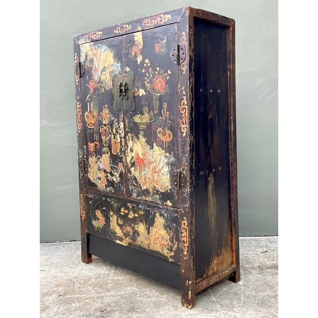 This monumental Chinese wedding cabinet is a captivating example of traditional lacquerware artistry, offering a rare...