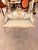 charming French Louis XVstyle canapé settee featuring a beautifully carved wood frame, soft floral upholstery, and a...