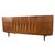 Exhibiting an extraordinary command of mid-century architectural rhythm, this vintage walnut triple dresser serves as a...