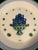 This vintage stoneware plate from M.A. Hadley features a hand-painted blue fruit/berry basket centerpiece surrounded by...