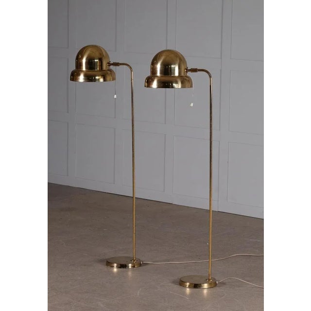Pair of floor lamp in brass, model G-120M manufactured by Bergboms, Sweden, 1960s. Measures: Height 120 cm. This piece is...