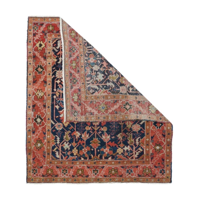 The dark blue field shows palmettes and deeply barbed leaves, all on stiff stems, with a layered hexagonal centre. Red...