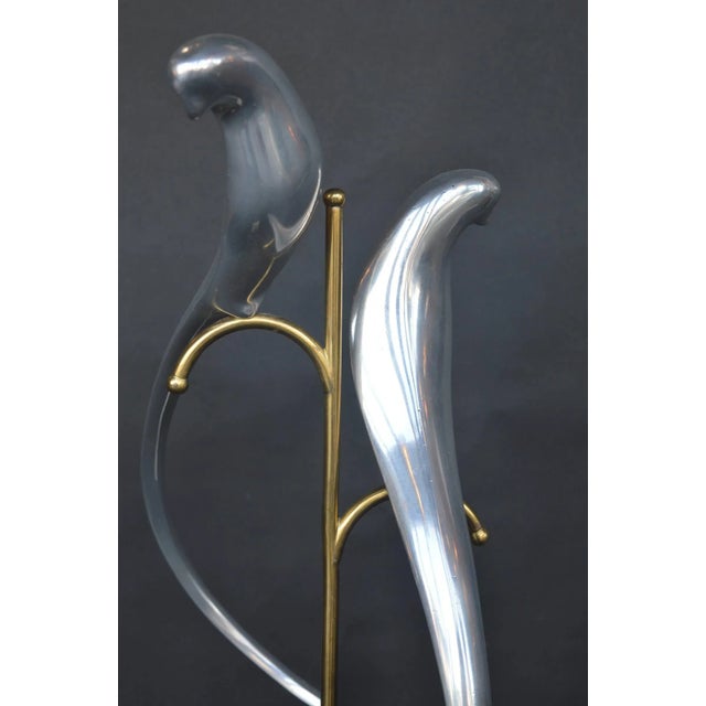 Metal sculpture of two parrots by Curtis Jere.