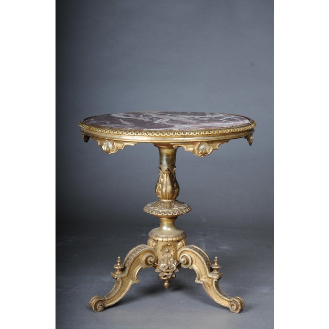 Magnificent antique side table gilded with marble top from around 1860 Richly carved solid wood body with rich ornaments,...