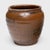 This antique Chinese jar from the early 20th century is cloaked inside and out with a beautiful drip glaze of warm brown...