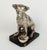Silvered bronze sculpture depicting a Jack Russell dog sitting in front of a bowl on which a snail is walking, signed F...