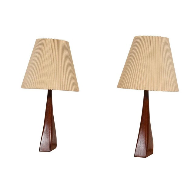 This amazing pair of lamps by Johannes Aasbjerg are biomorphic wedge shapes in teak. A very rare find! Example Dimensions:...