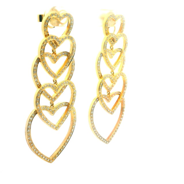 Striking diamond heart cascade earrings crafted in 18 karat yellow gold, featuring a dramatic articulated design composed...