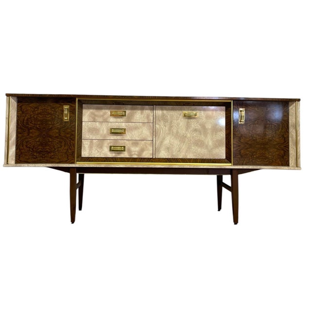 This vintage mid century modern credenza features a distinctive Formica laminate exterior with a dramatic faux wood-grain...