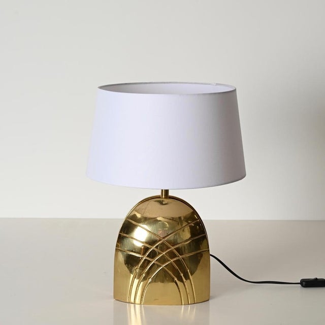 Beautiful large table lamp fully made in solid brass and completed by a white lampshade. This beautiful lamp was designed...