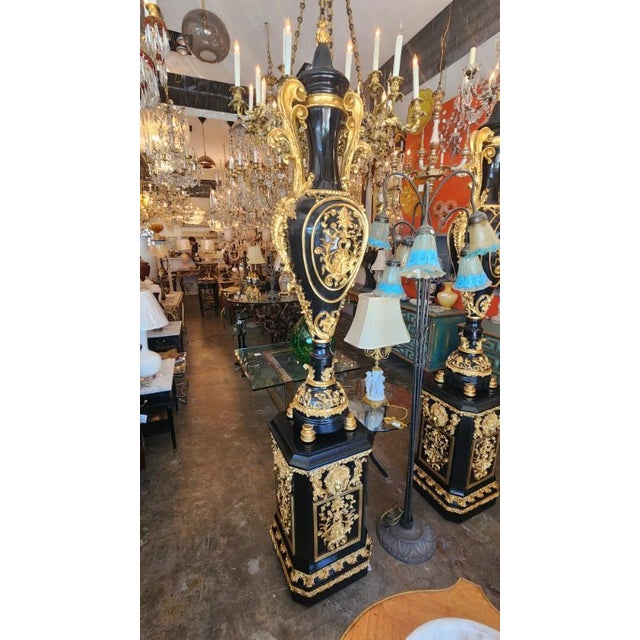 Hand carved painted black and gold painted vase statues, the vase and base can be separated. Sits very tall at 7 feet but...