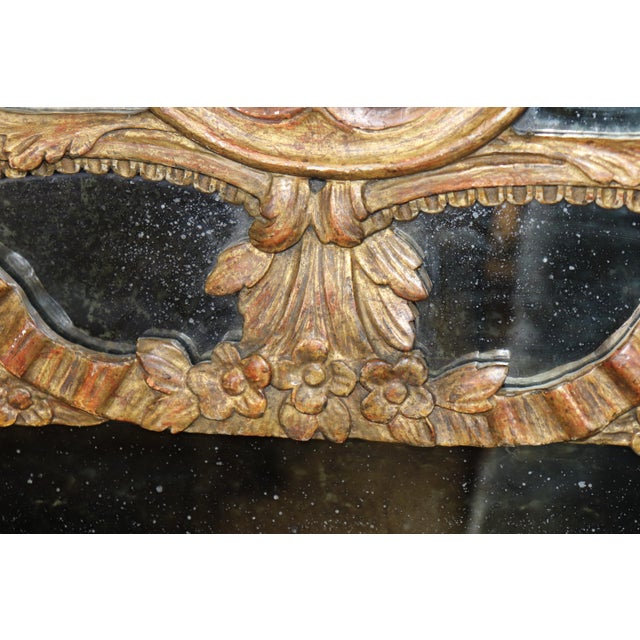 An exceptionally decorative Italian giltwood mirror dating from the early 20th century, this stunning piece exemplifies...