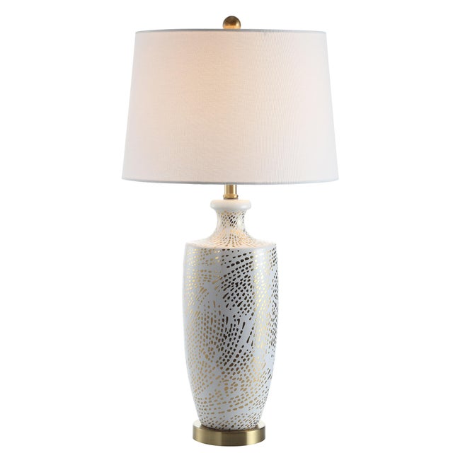 Designed to illuminate it's radiant finish, this contemporary table lamp upgrades any living room. it's finely crafted...