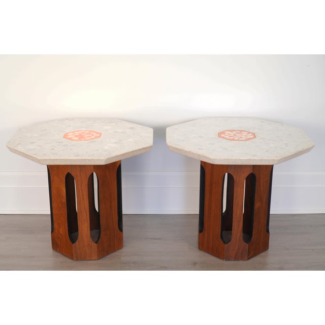 Designed and manufactured by Harvey Probber, these tables pair substantial terrazzo tops with walnut bases. They have age-...