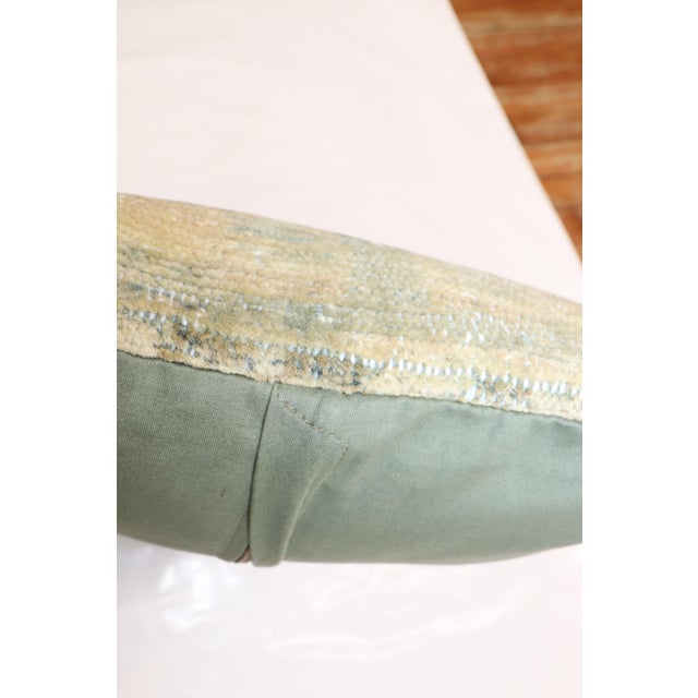 Pillow made from a soft green vintage persian rug