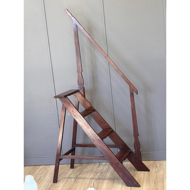 A late 18th century French mahogany library steps with a fixed A-frame form, stepped treads, and an integrated handrail...