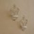 Two-piece set of decorative wall baskets made of white-painted metal with curved wire ornamentation. The design is...