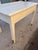 This work table is crafted from decorated wood, with a refined white finish that lends elegance and brightness to the...
