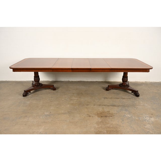 An exceptional Regency or Neoclassical style double pedestal extension dining table By Baker Furniture USA, Circa 1980s...