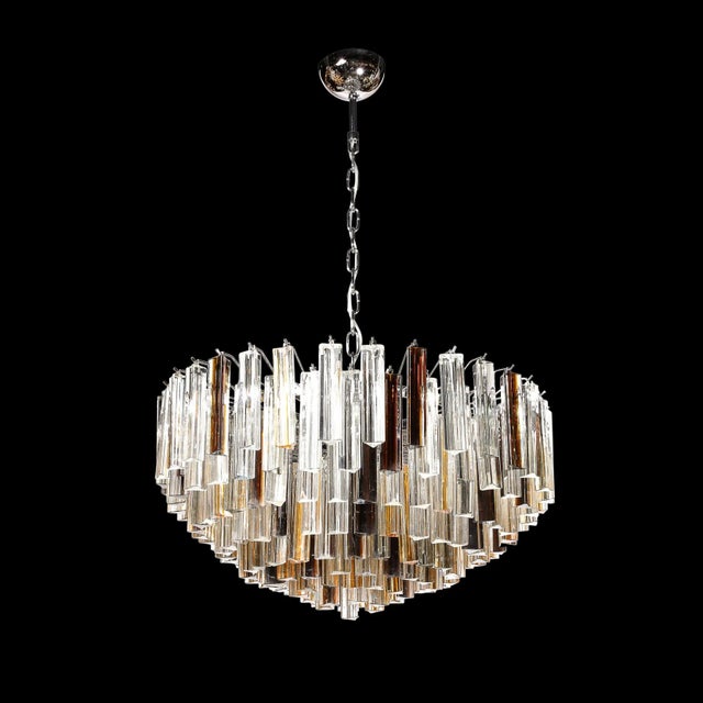 This elegant Modernist Hand-Blown Murano Glass Tridre Chandelier in Mixed Amber, smoked and clear originates from Italy...