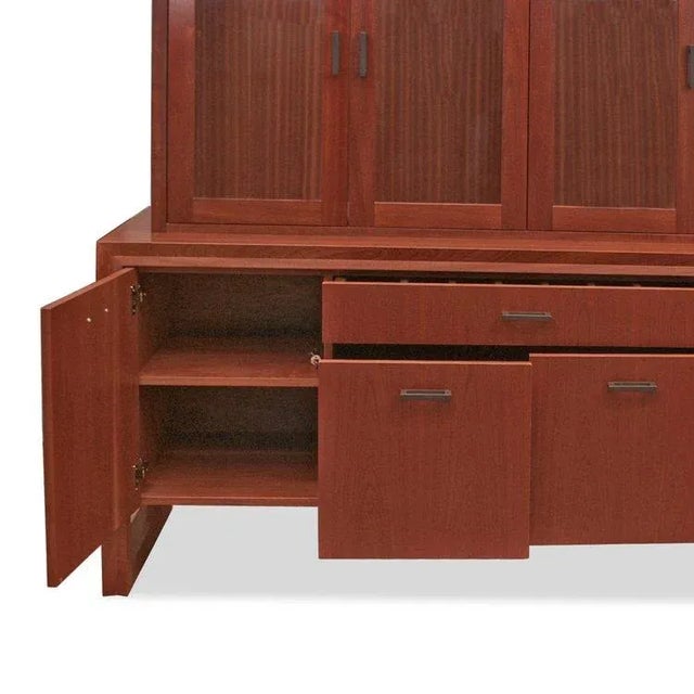 This contemporary custom buffet with a hutch display case in burnt umber offers a stylish and versatile storage solution...