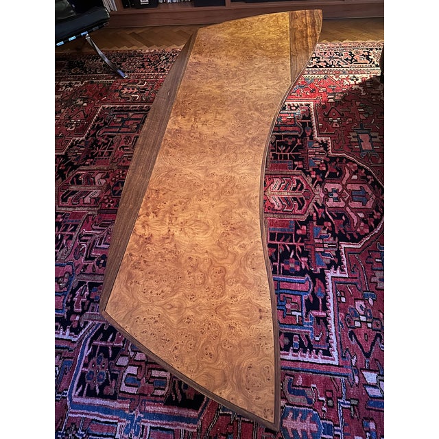 Dramatic long mid-century coffee table crafted of exquisitely composed rosewood burled wood, set in walnut bezel. Coloring...