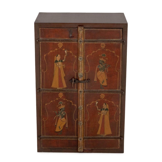 Indian Paint-Decorated Two-Door Cabinet, the doors hand-painted with figural scenes and opening to three shelves. 35" H x...