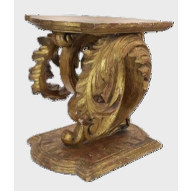 An expressive antique Rococo-style giltwood fragment, originally part of a larger console or pedestal table form. This...