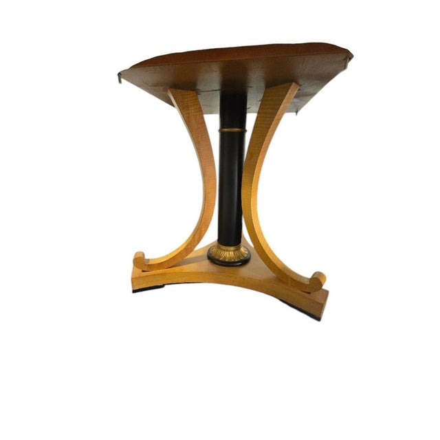 A stunning Baker Furniture dining table featuring a rectangular top with finely inlaid border detail, supported by two...