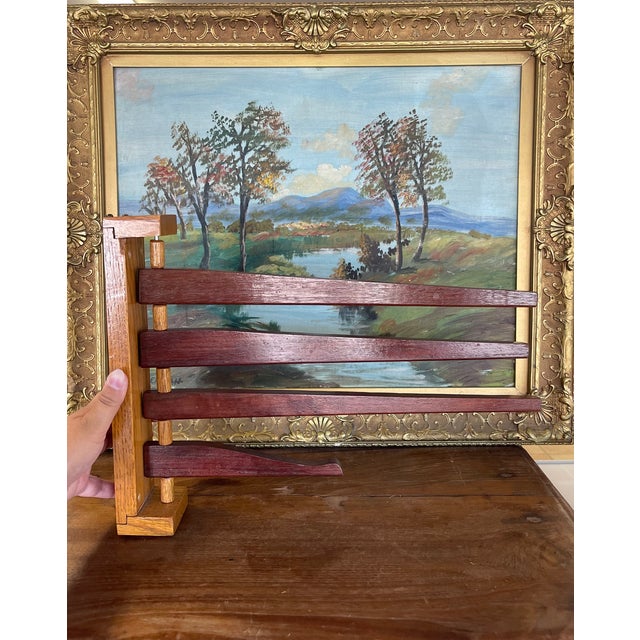 This vintage wooden wall-mounted rack features a swing-arm design with four rotating arms, ideal for displaying or storing...