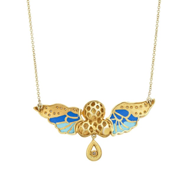 Stylish and finely detailed winged angel necklace crafted in 14k yellow gold. Diamonds total an estimated 0.50 carats...