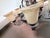 A charming six-arm wrought iron chandelier with frosted cream glass bell shades and twisted arm detailing. Dark iron...