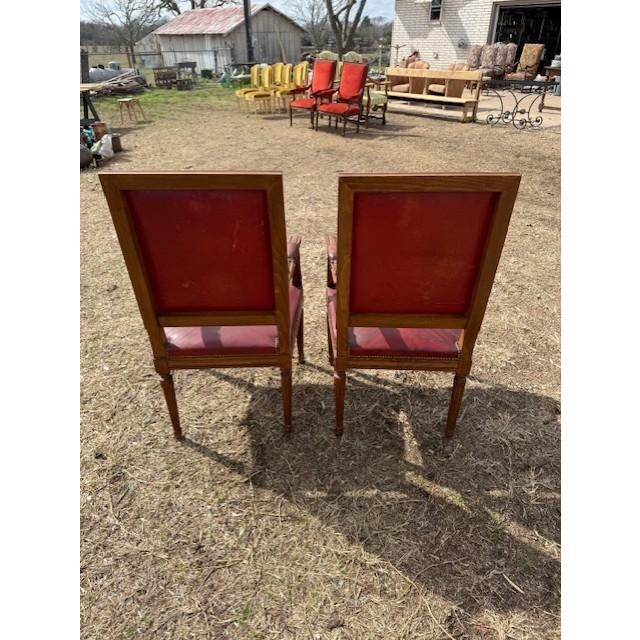 Large Pair of French Louis XVI Armchairs from France made of solid mahogany, the wood has been finished with a lustrous...