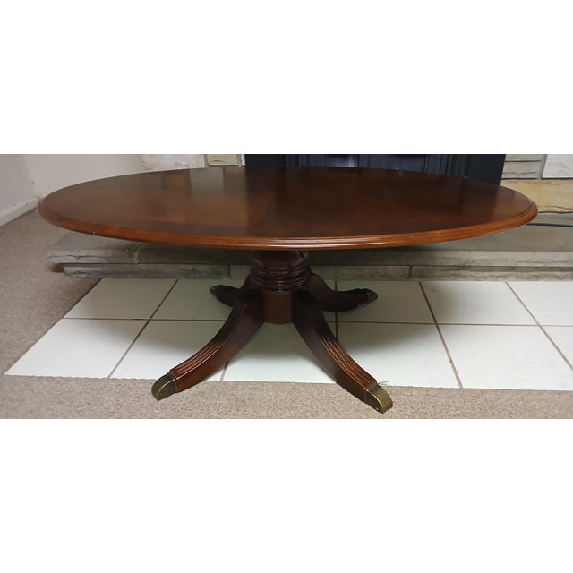 Vintage Mahogany Oval Coffee Table with Brass Accents This elegant vintage mahogany oval coffee table exudes timeless...