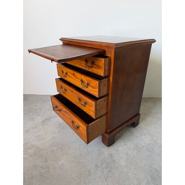 This elegant vintage Georgian Campaign-style chest is crafted from richly figured mahogany with beautiful satinwood-style...