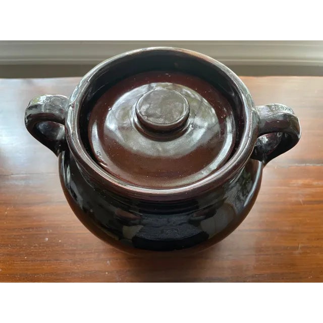 This is a classic heavy New England Stoneware Bean Pot for slow cooking baked beans in the oven. It has a deep brown high...