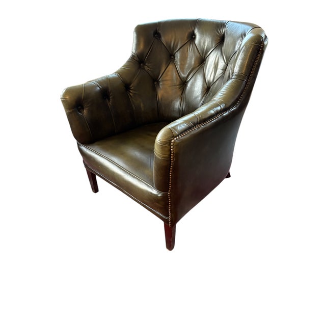 Rich green leather with diamond tufting Elegant nailhead trim and wooden legs Curved arms and deep seat Chesterfield-...