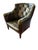 Rich green leather with diamond tufting Elegant nailhead trim and wooden legs Curved arms and deep seat Chesterfield-...